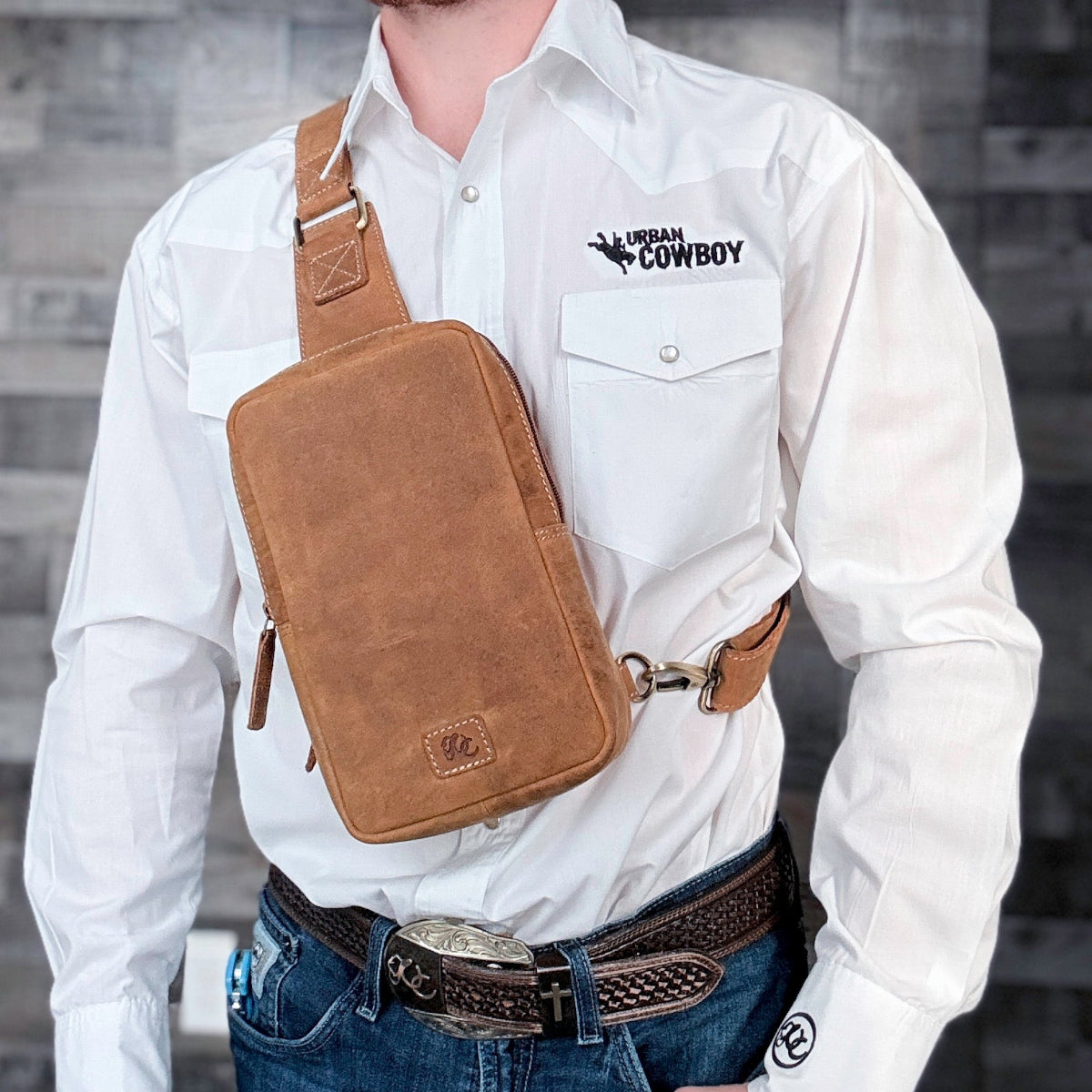 Full-grain brown leather CCW sling bag with hidden magnetic back pocket